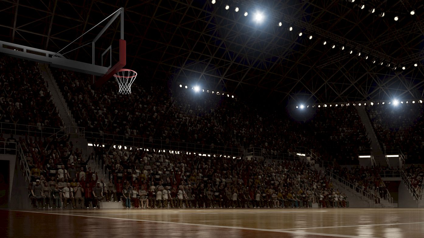 A dimly lit basketball arena with spectators in the stands during a game, focusing on the court and hoop under bright lights.
