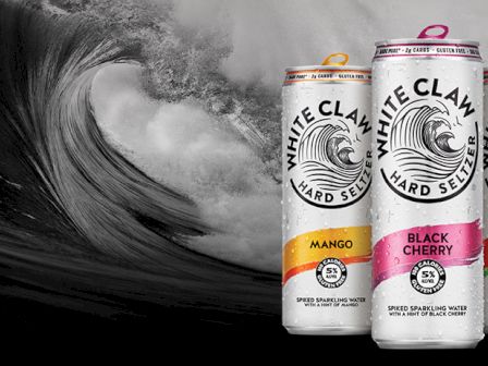 Cans of White Claw Hard Seltzer in Mango, Black Cherry, and Watermelon flavors are set against a wave background.